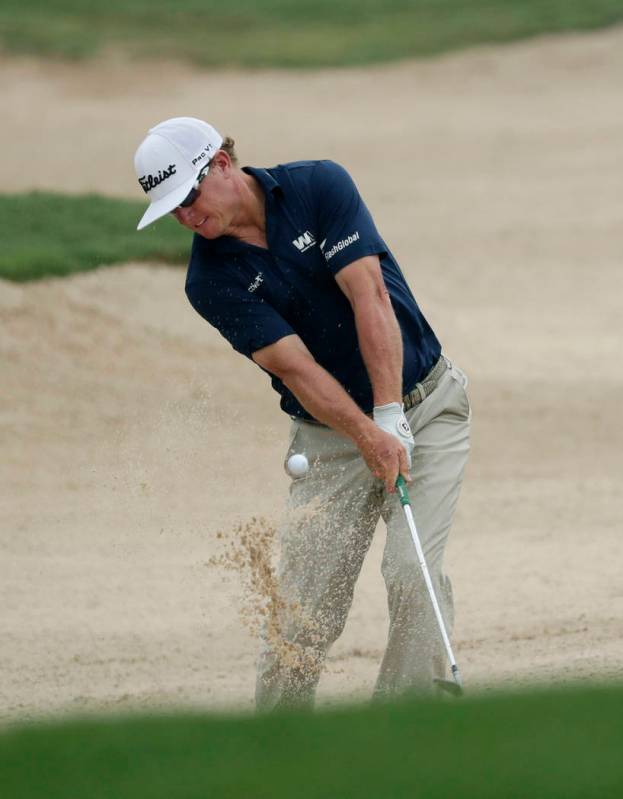 Charley Hoffman plays a shot from a bunker on the 14th hole during the third round of the Texas ...