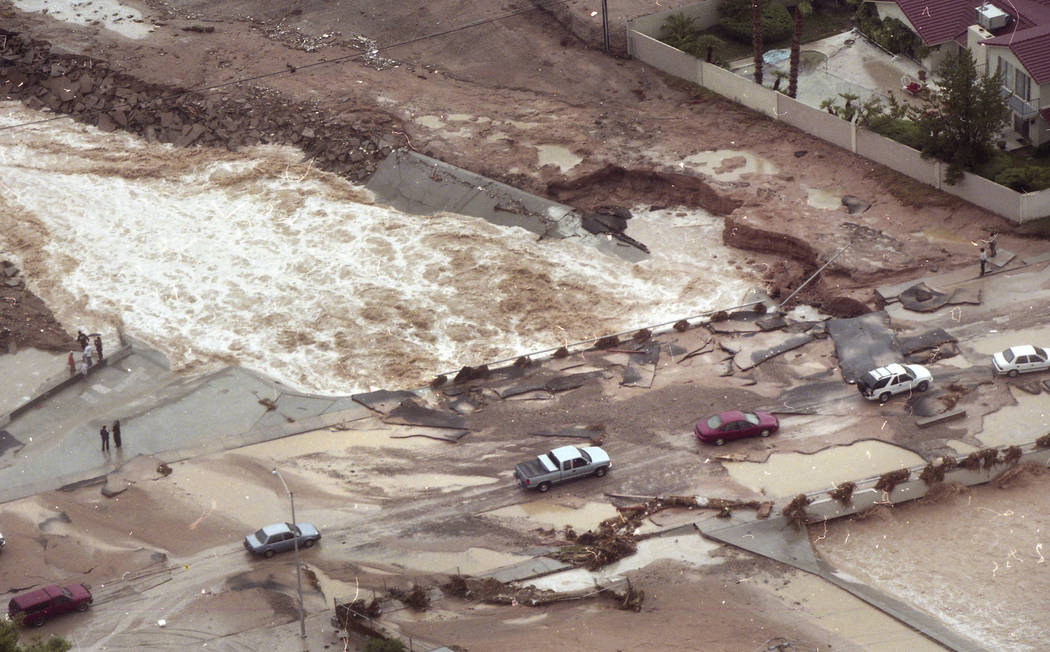 Cars pick their way across broken pavement on the Spencer Street bridge over Flamingo Wash on J ...