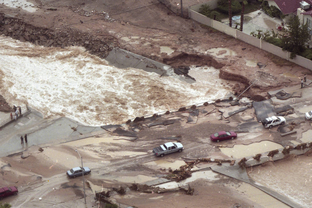 Cars pick their way across broken pavement on the Spencer Street bridge over Flamingo Wash on J ...