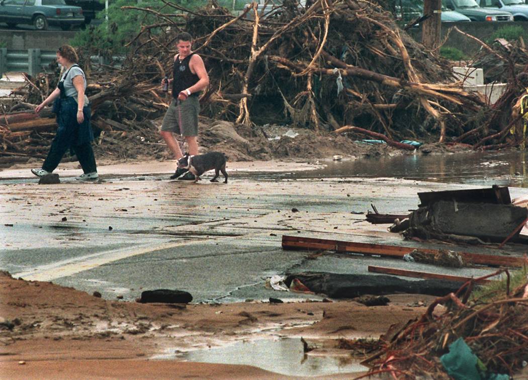 Deana and Ron Bender, residents of the Miracle Mile trailer park walk near their home along Bou ...