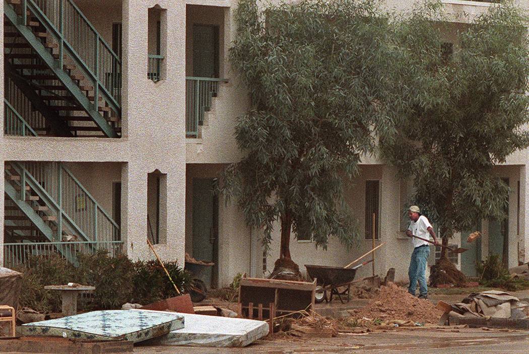 A worker cleans up flood debris at The Ramada Limited Hotel on Boulder Highway. (Las Vegas Revi ...