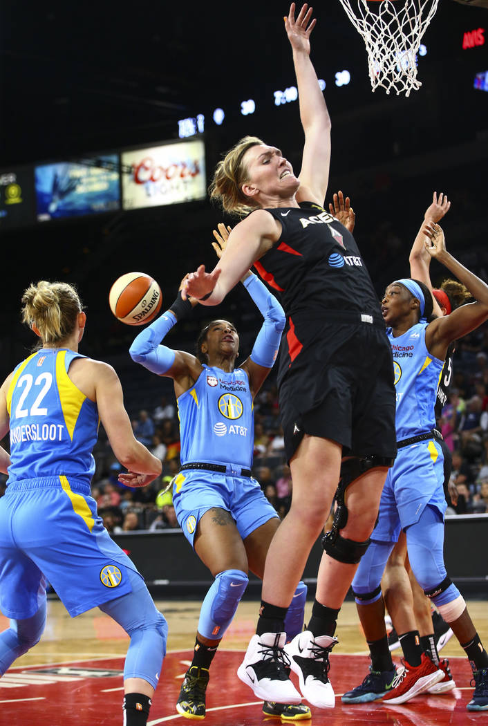 Las Vegas Aces' Carolyn Swords, center right, goes for a rebound against Chicago Sky defenders ...