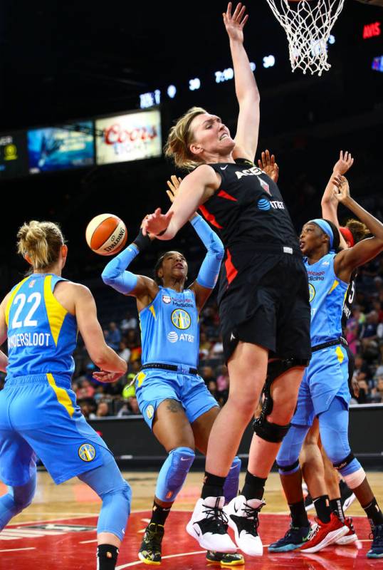 Las Vegas Aces' Carolyn Swords, center right, goes for a rebound against Chicago Sky defenders ...