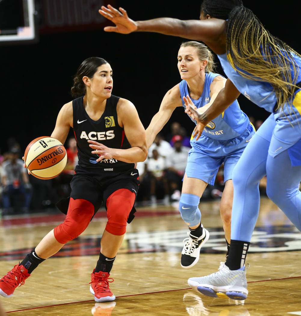 Las Vegas Aces' Kelsey Plum drives the ball under pressure from Chicago Sky's Allie Quigley dur ...