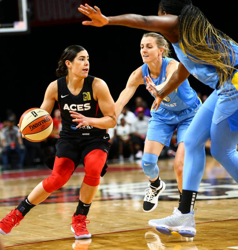 Las Vegas Aces' Kelsey Plum drives the ball under pressure from Chicago Sky's Allie Quigley dur ...