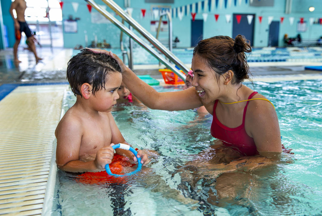 Swim instructor Shanneal Ocular talks with her student Louis Borado, 3, during a beginner swim ...