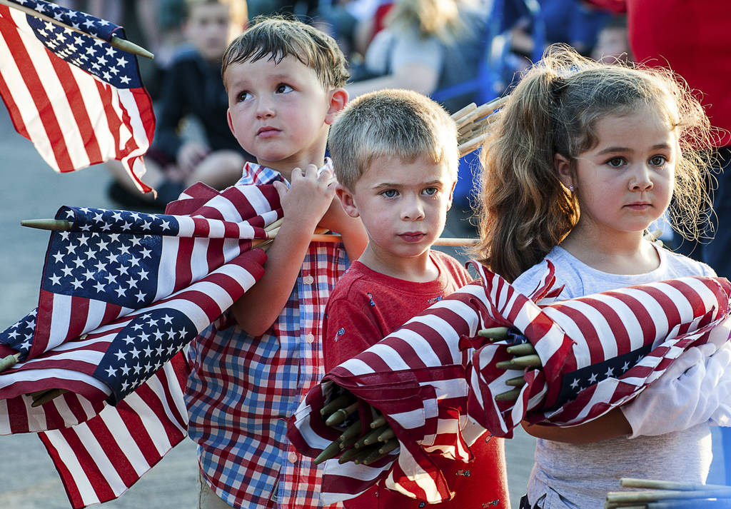 Brayden Austin, left, Gavin Colby, middle, and Brylee Roberge patiently wait with an armful of ...