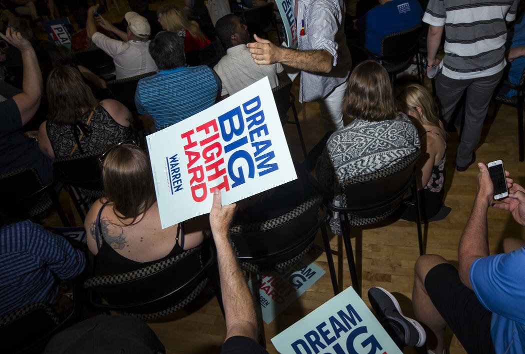 Signs are passe out in support of Democratic presidential candidate Sen. Elizabeth Warren, D-Ma ...