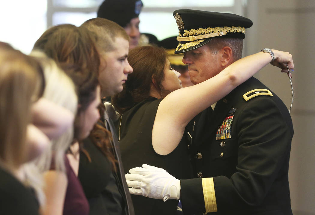 Brig. Gen. Zachary Doser, right, embraces Margie Gallagher during a funeral for her husband Nev ...