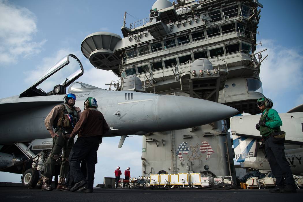 FILE - In this June 3, 2019 file photo, a pilot speaks to a crew member by an F/A-18 fighter je ...