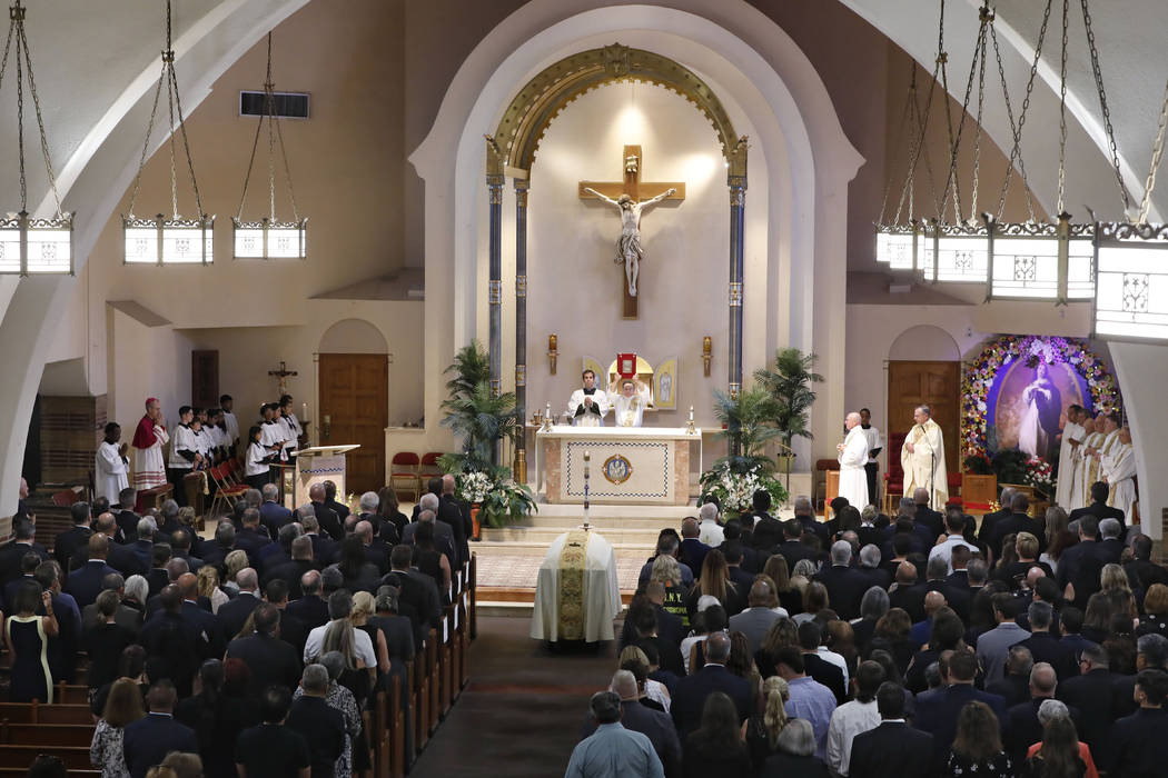 A church deacon officiates during the funeral ceremony for Detective Luis Alvarez, at Immaculat ...