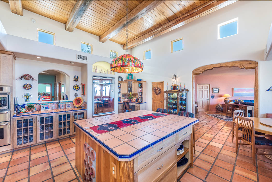 The colorful Southwestern kitchen features Saltillo tile flooring. (Desert Sun Realty)