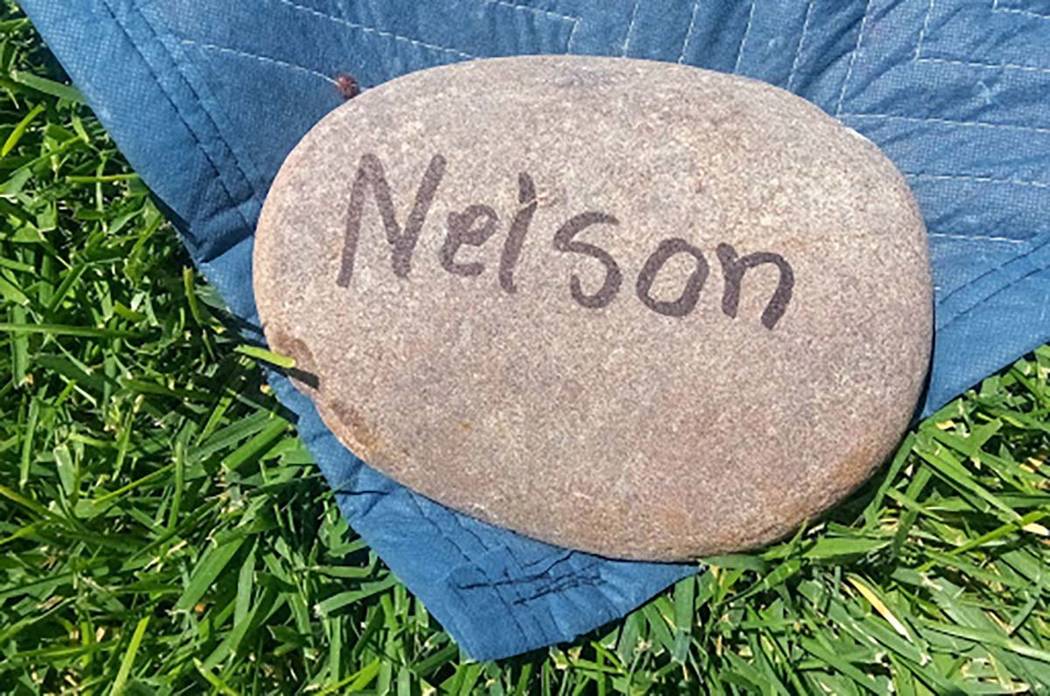 A "Nelson" rock holds down a corner of a blanket for their place to view Thursday's Summerlin C ...