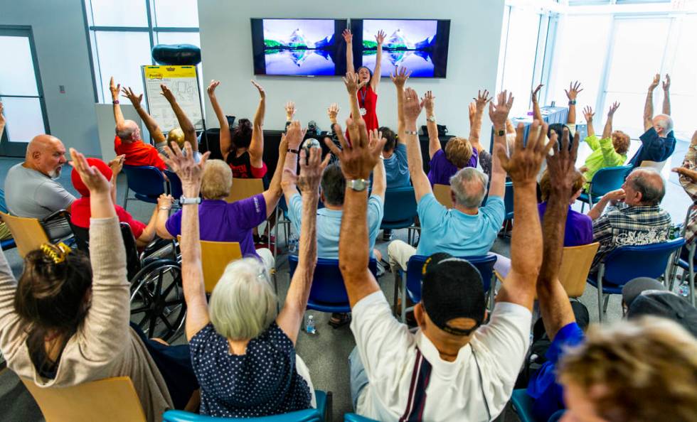 Administrative Assistant II Verla Niebuhr leads the many participants in some group exercises a ...