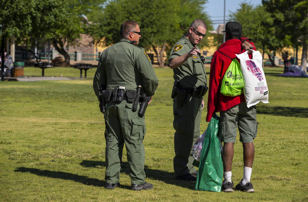 Metropolitan Police Department officers Keith Hanoff, left, and Kerry Reusch, center, make cont ...