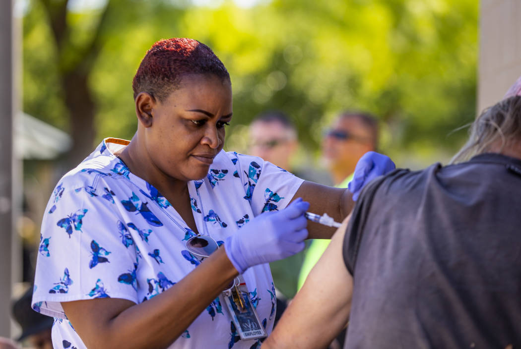 Tasheka Powell, Southern Nevada Health District registered nurse, gives a homeless man a Hepati ...