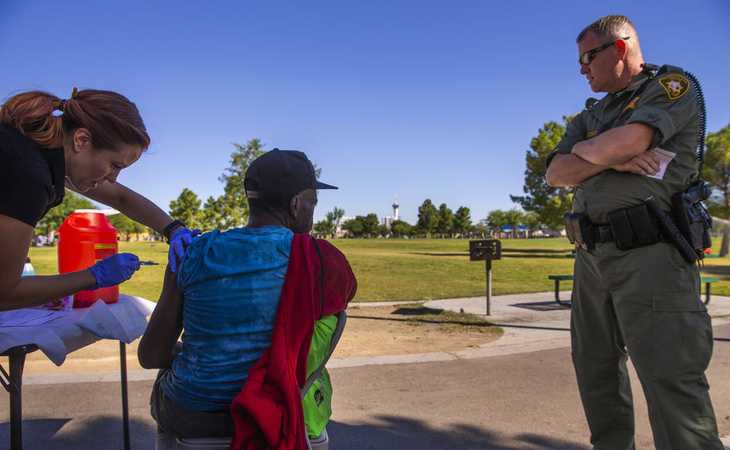 Sarah Lugo, Southern Nevada Health District senior community health nurse, gives a homeless man ...