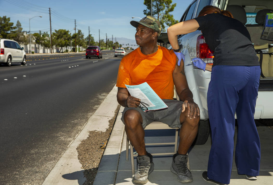 Sarah Lugo, Southern Nevada Health District senior community health nurse, administers a shot t ...