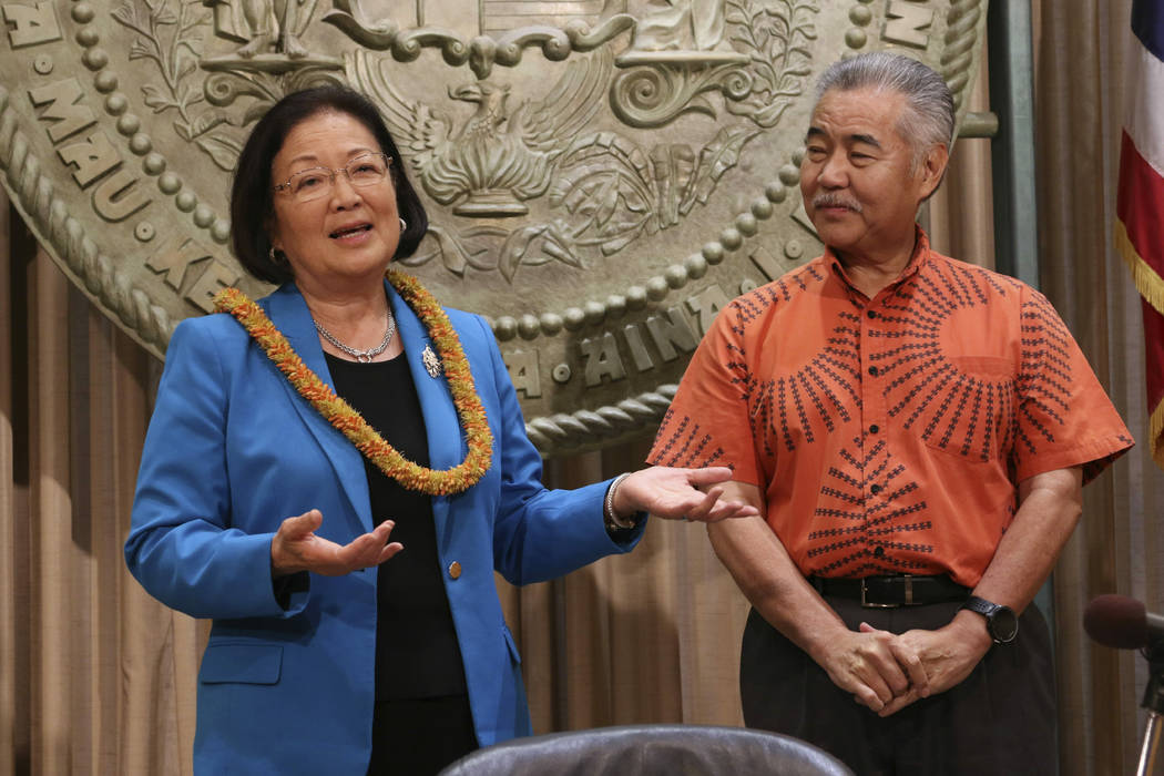 Hawaii Gov. David Ige, right, listens as U.S. Sen. Mazie Hirono speaks before Ige signs bills i ...