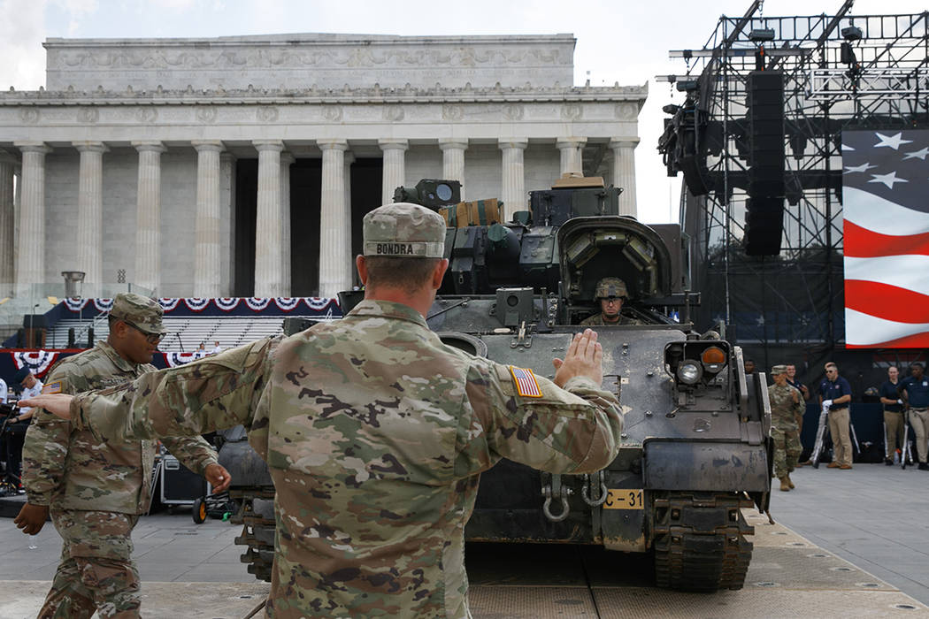 Soldiers with the 3rd Infantry Division, 1st Battalion, 64th Armored Regiment, move a Bradley F ...