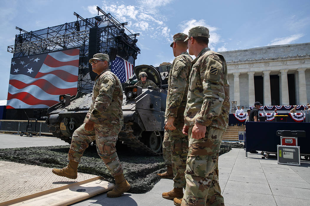 Army personnel manuever a Bradley Fighting Vehicle into place by the Lincoln Memorial, Wednesda ...