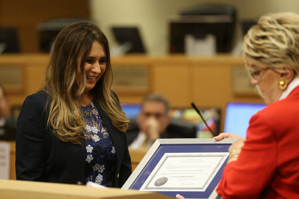 New Councilwoman Victoria Seaman receives a certificate of election from Mayor Carolyn Goodman ...