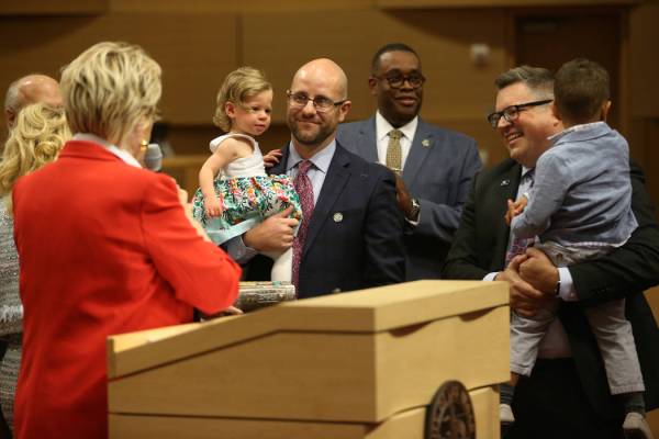 New Councilman Brian Knudsen, center, holding his daughter Kate, 1, with his husband Brian Eaga ...