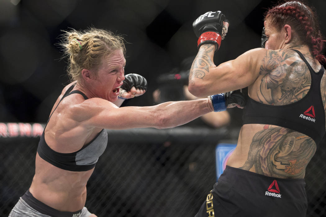 Holly Holm, left, battles Cris "Cyborg" Justino in the UFC 219 women’s feather ...