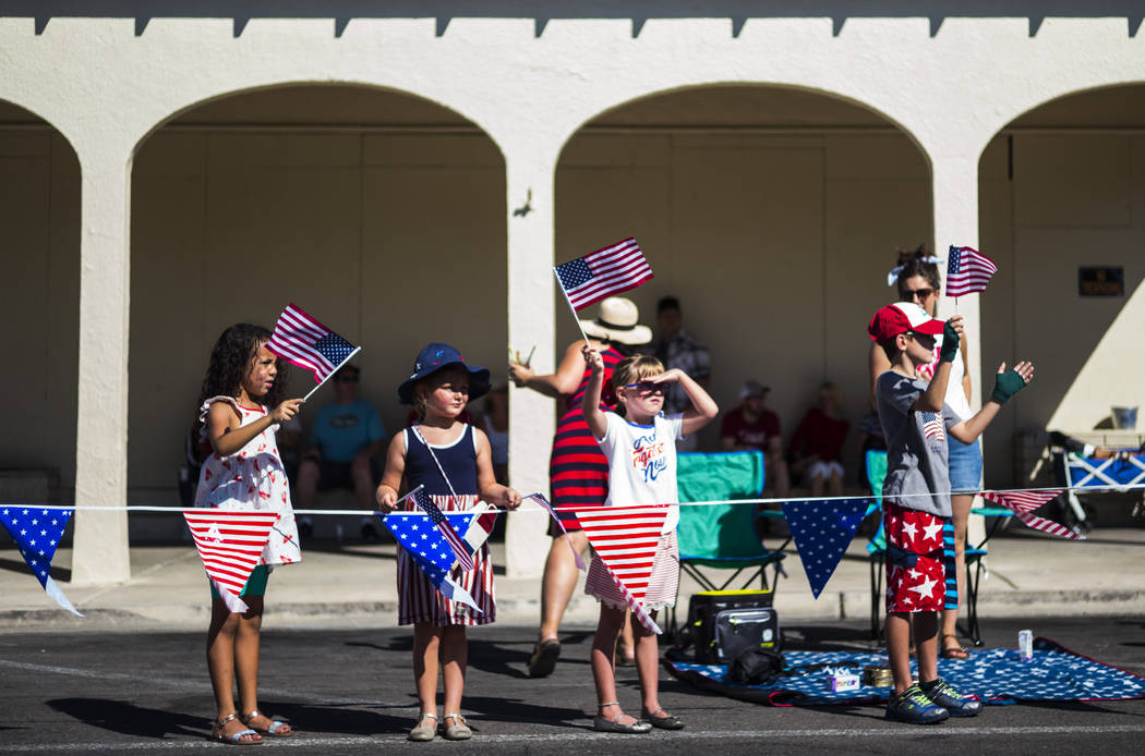 Spectators watch parade participants pass by during the annual Damboree Celebration in Boulder ...