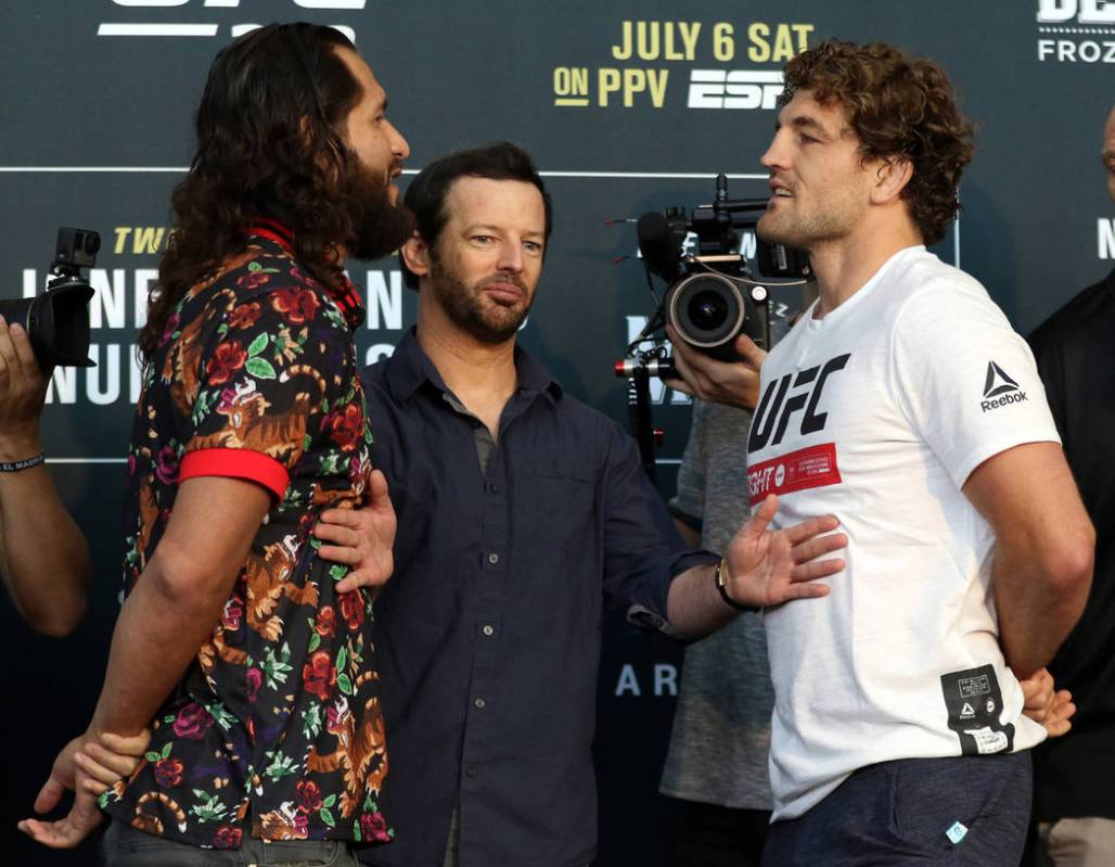 UFC welterweight Jorge Masvidal, left, and Ben Askren, right are kept apart by matchmaker Sean ...