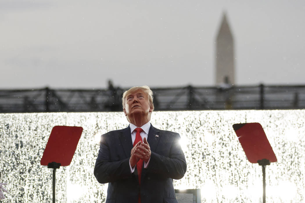 President Donald Trump looks up during the military flyovers at the Independence Day celebratio ...