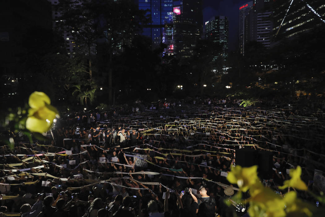 Attendees hold up banners during a rally by mothers In Hong Kong on Friday, Jan. 5, 2019. Stude ...