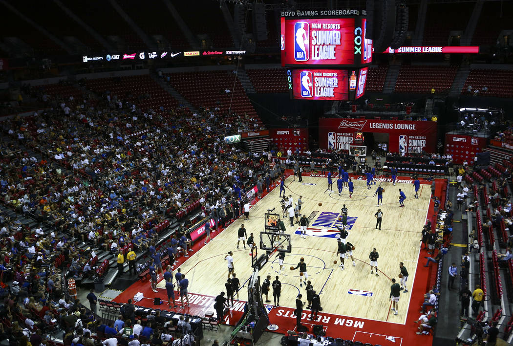 Players for the Milwaukee Bucks and Philadelphia 76ers warm up before the start of a basketball ...