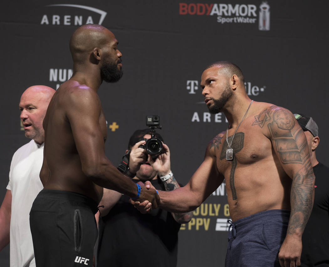 UFC light heavyweights Thiago Santos, right, shakes hands with Jon Jones during weigh ins for U ...