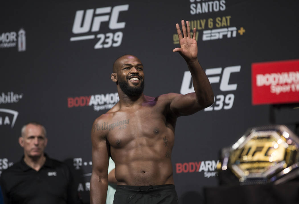 UFC light heavyweight champion Jon Jones waves to his fans during weigh ins for UFC 239 on Frid ...