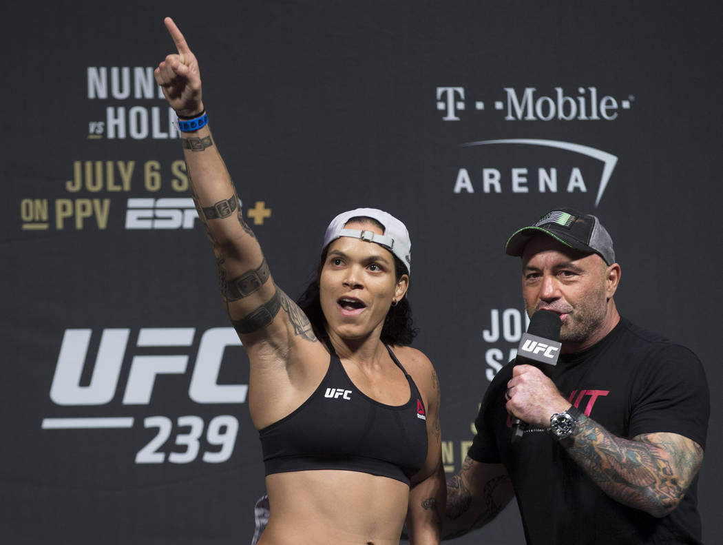 UFC bantamweight champion Amanda Nunes, left, points at her fans while speaking with Joe Rogan ...