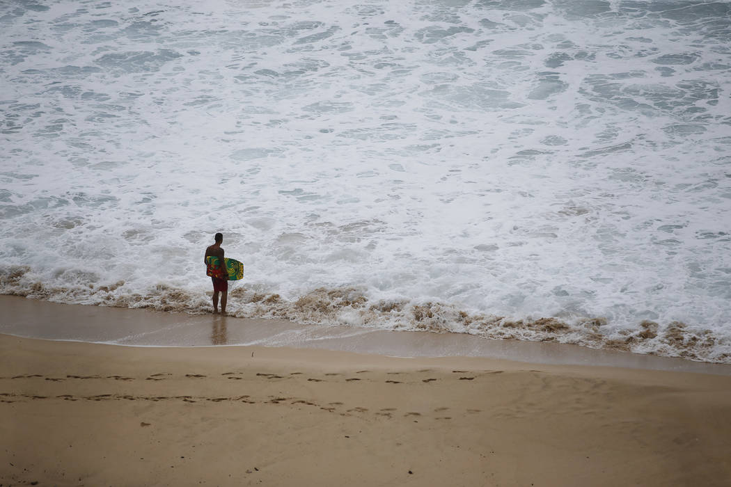 A boogie boarder stands near the surf at Makapu'u Beach, Friday, Aug. 24, 2018, in Waimanalo, H ...