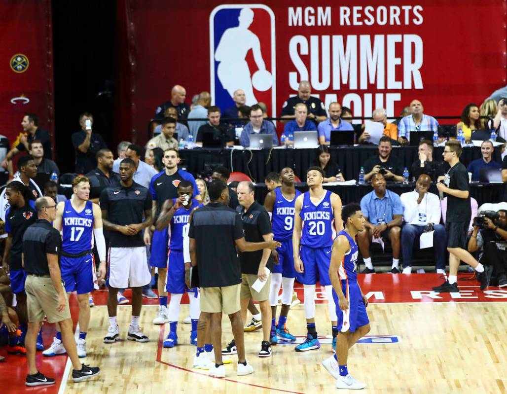 Members of the New York Knicks look on after an earthquake halted their basketball game against ...