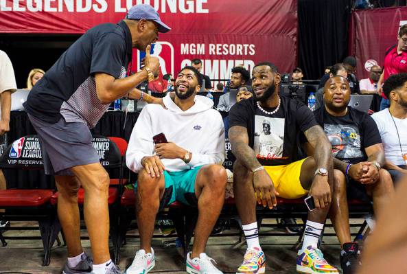 Los Angeles Lakers' Anthony Davis, second from left, and LeBron James mingle with people courts ...