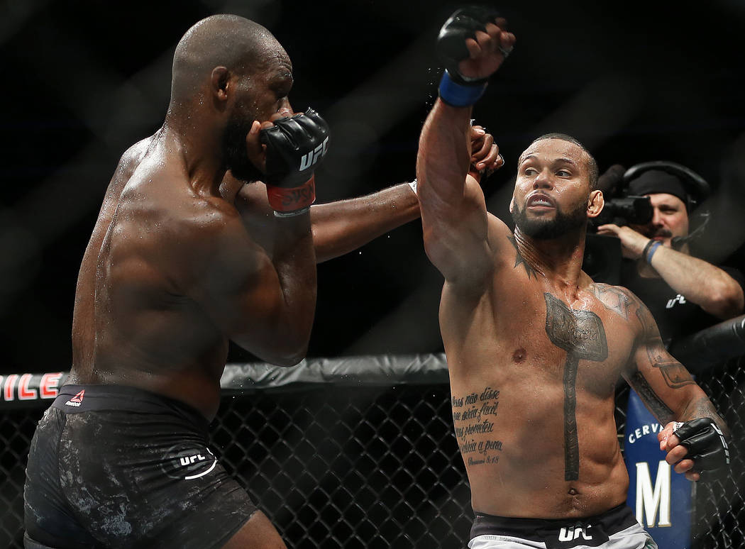 Thiago Santos, right, throws a right hook against Jon Jones in the first round during their li ...