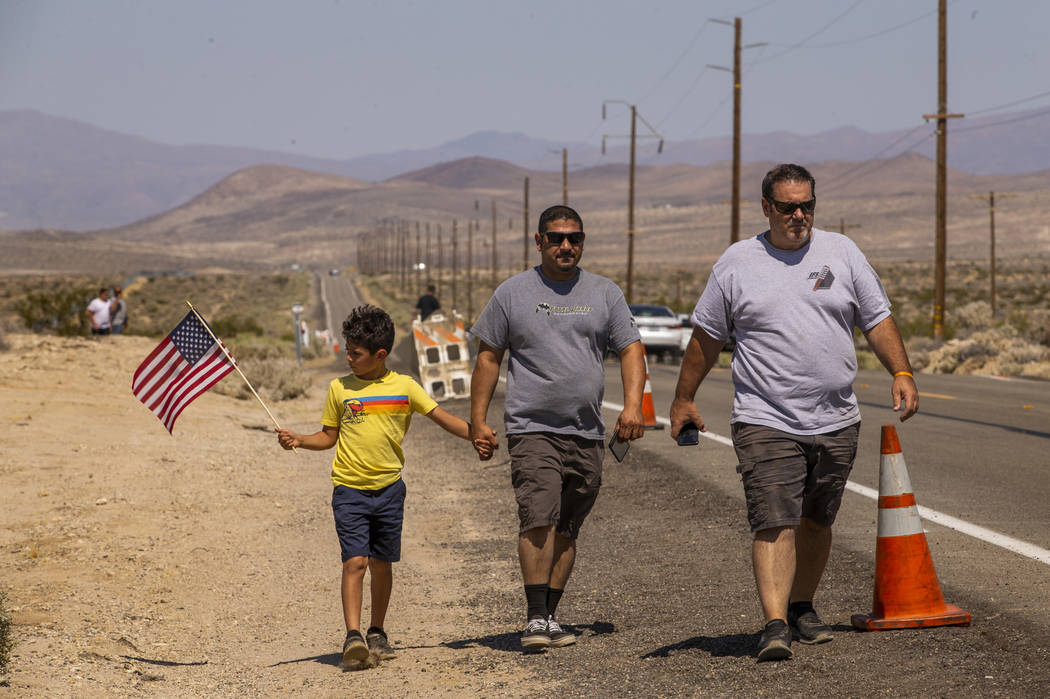 (From left) Aiden Dadebhoy, 8, and his father Zeshan walk with Tom Velez as they look to view t ...