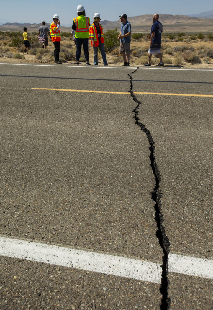 Caltrans workers continue to monitor the extensive cracks with shifting pavement that have open ...