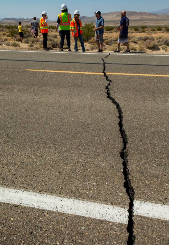 Caltrans workers continue to monitor the extensive cracks with shifting pavement that have open ...