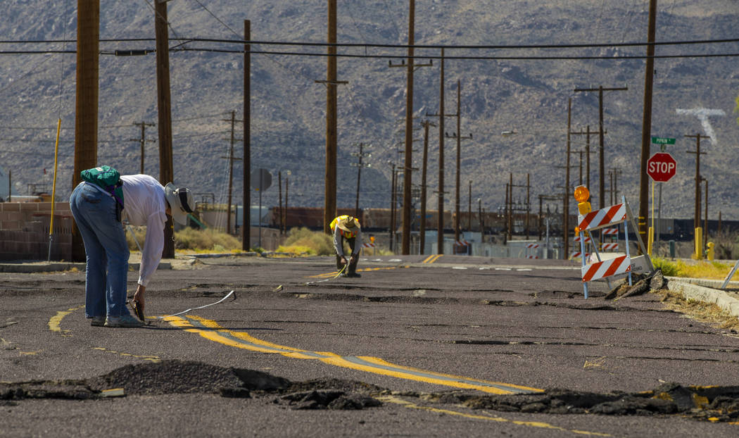 Scientists working along side the USGS measure and monitor the extensive cracks with shifting p ...