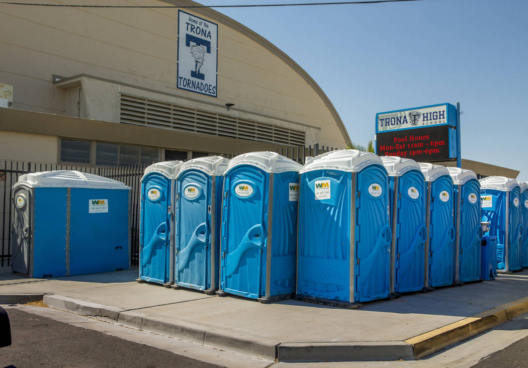 A line of porta potty's line the sidewalk outside the Trona High School as water and other supp ...