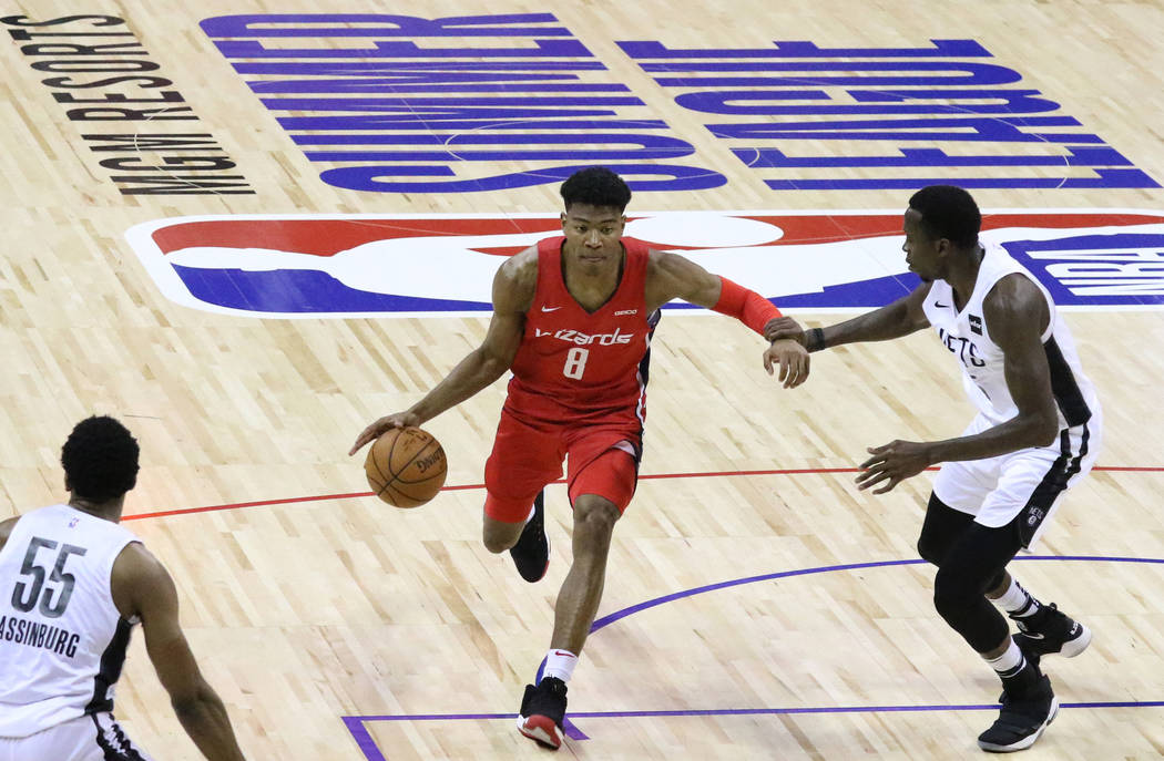 The Washington Wizards' forward Rui Hachimura (8) drives past the Brooklyn Nets' center Amida B ...