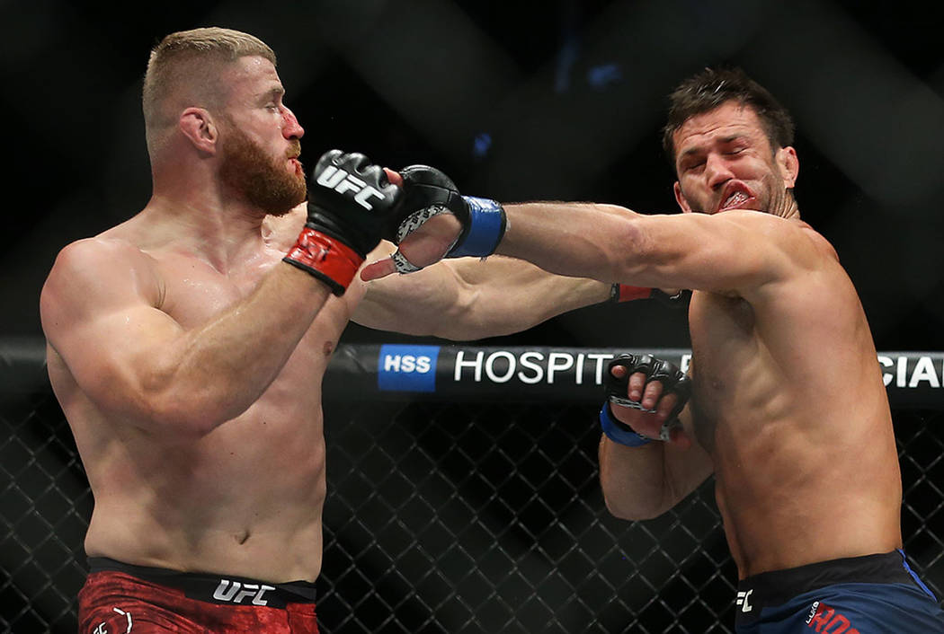 Jan Blachowicz, right, connects with a right hook against Luke Rockhold in the second round dur ...