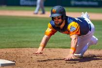 The Aviators Nick Martini (38) dives back to first base during a game versus the Tacoma Rainier ...