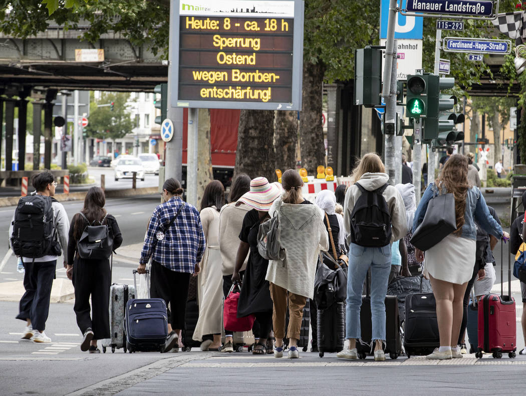 People leave the forbidden area near the European Central Bank as 16 000 people are evacuated p ...