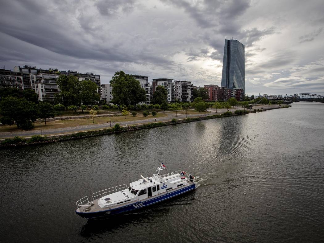 A police boat patrols on the river Main near the European Central Bank, background as 16 000 pe ...